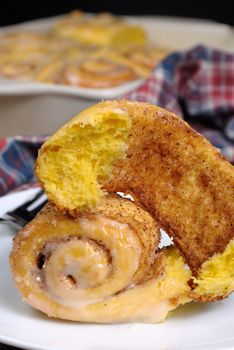Broken bun of pumpkin with cinnamon in the form of snails closeup
