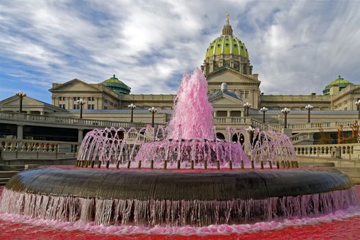 The waters in the Capitol East Wing fountain are dyed pink signifying the start of Breast Cancer Awareness Month in October. Harrisburg, Pennsylvania, USA.