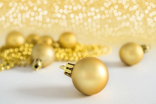 Golden Christmas balls background decoration lights snow winter copyspace. Christmas decorations
