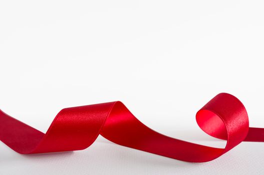 Red satin ribbon isolated on white background