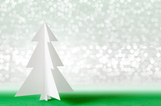 Christmas tree with lights snow winter background. Christmas tree paper craft.