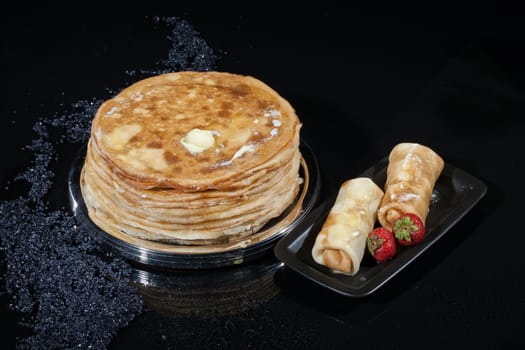 Pancakes in a plate on a glass studio background