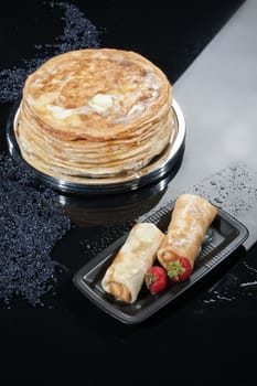 Pancakes in a plate on a glass studio background