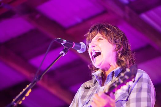 HOT SPRINGS, NC - AUGUST 10: Amy Ray of the Indigo Girls sings and plays guitar on stage at the Christian themed Wild Goose Festival on August 10, 2013 in Hot Springs, NC, USA