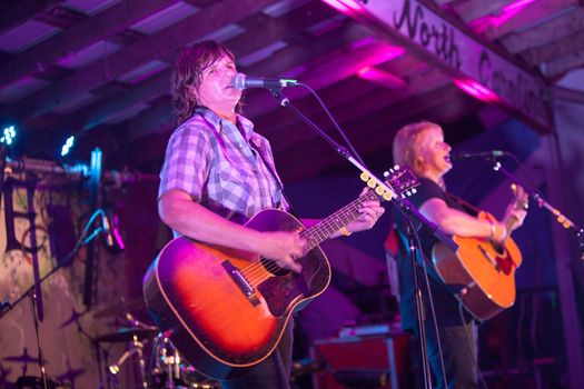 HOT SPRINGS, NC - AUGUST 10: The Indigo Girls perform on a stage lit with purple lights at the Christian oriented Wild Goose Festival on August 10, 2013 in Hot Springs, NC, USA