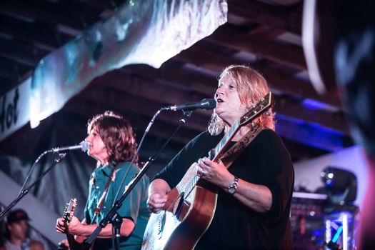 HOT SPRINGS, NC - JULY 9: Indigo Girls duo Amy Ray and Emily Sailers singing on stage at Wild Goose Festival on July 9, 2016 in Hot Springs, NC, USA.