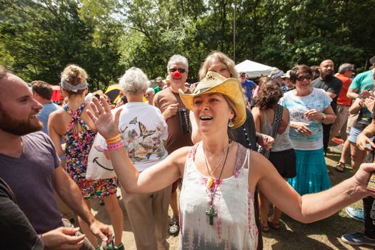 HOT SPRINGS, NC - JULY 10: Enthusiastic Christian woman in crowd of worshipers at the Wild Goose Festival on July 10, 2016 in Hot Springs, NC, USA.