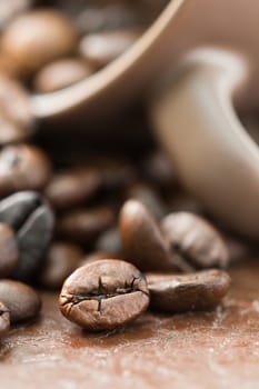 Close up roasted coffee beans and coffee cup