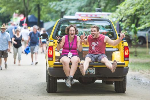 HOT SPRINGS, NC - JULY 8: Happy Wild Goose Festival staff with walkie talkie on back of pickup truck on July 8, 2016 in Hot Springs, NC, USA.