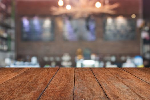 Brown table top with blurred coffee shop interior for background