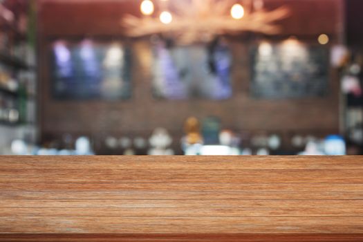 Brown wooden table top with blurred cafe background. product display template