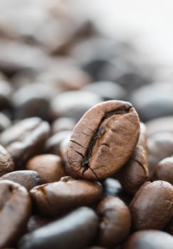 Close up heap of roasted brown coffee beans