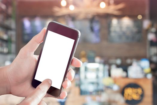 Woman using smartphone with blurred cafe background, stock photo