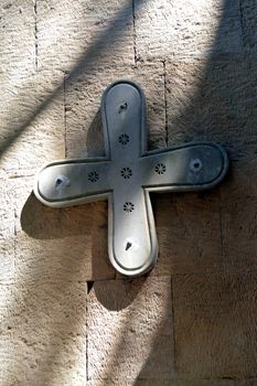 Concrete cross on in roof with a sunset and a blue sky.