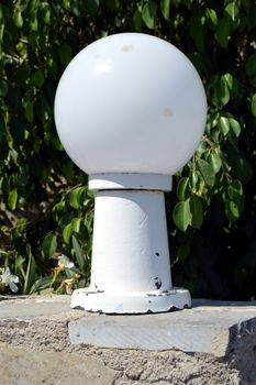 Lamp on foot with white ball for outside lighting.