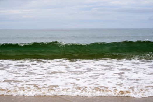 clean green waves breaking on the beach in ballybunion county kerry ireland