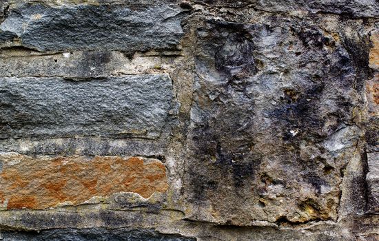 Background of Ancient Castle Wall with Old Stones and Concrete closeup Outdoors