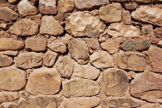 Old rough stone wall, background wallpaper                               