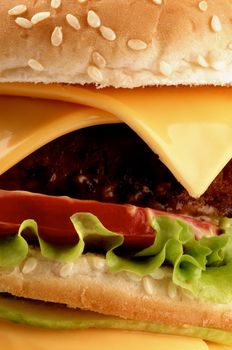 Big Tasty Double Cheeseburger with Beef, Tomato, Lettuce and Cheese on Sesame Bun closeup as Background