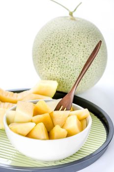 freshly cut cantaloupe melon on white background