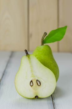 One and a half green pears over white background