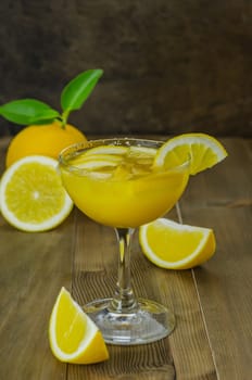 Fresh orange juice on wooden table over grunge background