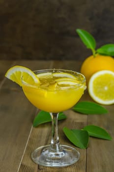 Fresh orange juice on wooden table over grunge background