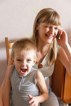 Screaming kid and mom talking on the phone