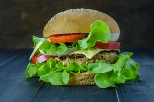 Closeup of home made burgers on wooden background