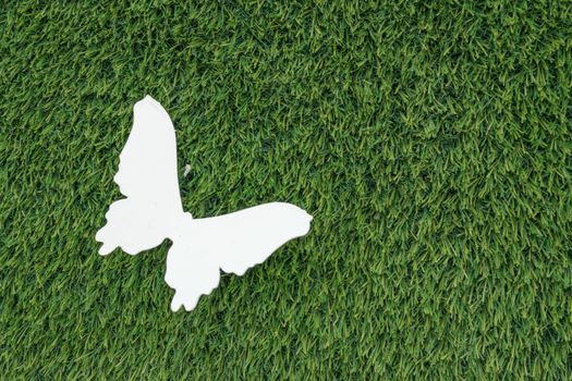 Artificial grass with white butterfly