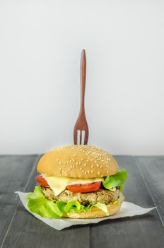 Closeup of home made burgers on wooden background