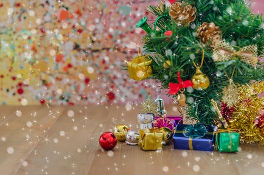 Christmas background with decorations and gift boxes on wooden board