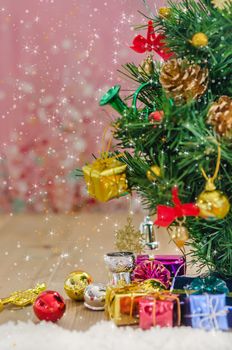 Christmas background with decorations and gift boxes on wooden board