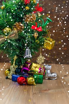 Christmas background with decorations and gift boxes on wooden board