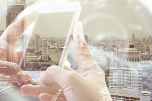 Double exposure of man using smart phone and cityscape background ,Business technology concept.