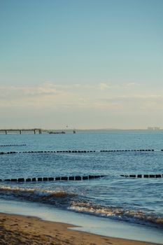 Breakwaters in the Baltic sea over the sunset in summer