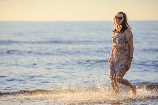 People walking on the beach in the ocean. Summer time