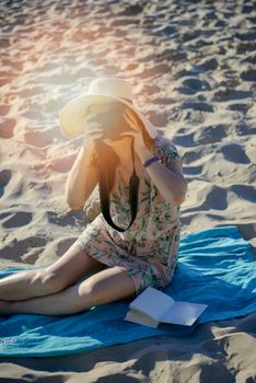 professional woman photographer on the beach, summer time