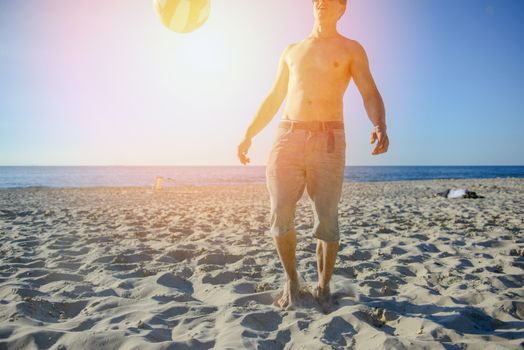 man playing soccer on beach with dribble skill and ball on vacation