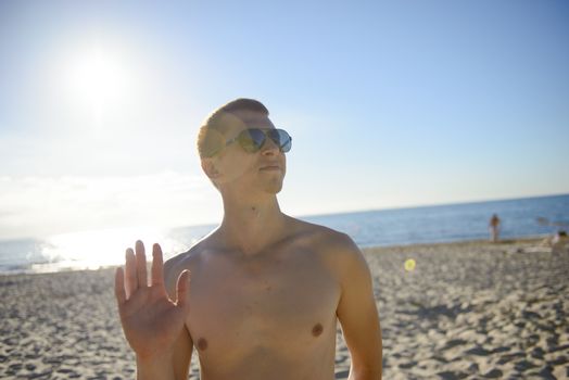 Young man finally at the beach without a t-shirt. Summer time