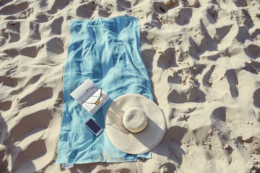 beach background with hat, towel and glasses