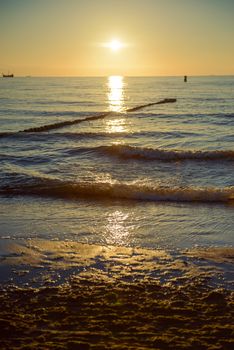 Breakwaters in the Baltic sea over the sunset in summer