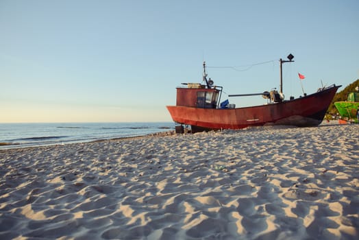 fisherman boats at sunrise time on the beach in summer