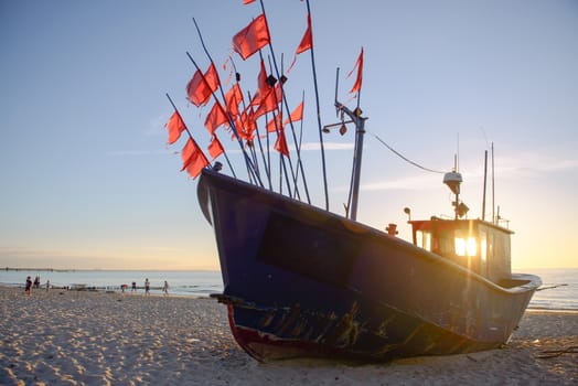 fisherman boats at sunrise time on the beach in summer