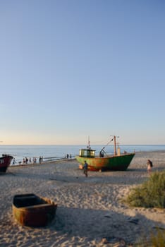 fisherman boats at sunrise time on the beach in summer