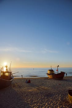 fisherman boats at sunrise time on the beach in summer