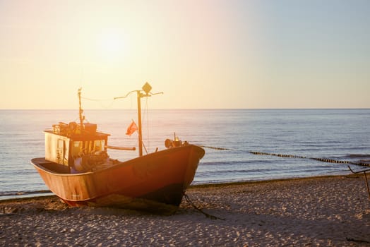 fisherman boats at sunrise time on the beach in summer