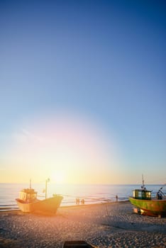 fisherman boats at sunrise time on the beach in summer