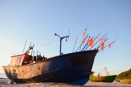 fisherman boats at sunrise time on the beach in summer