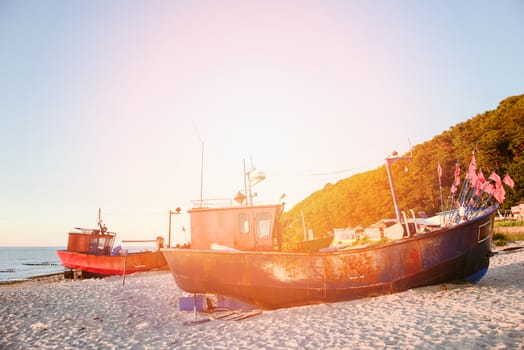 fisherman boats at sunrise time on the beach in summer